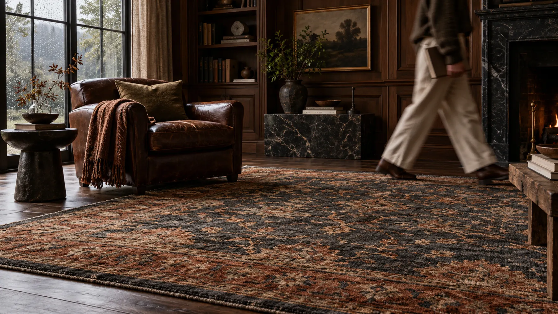 Handmade rug in a moody walnut-paneled room