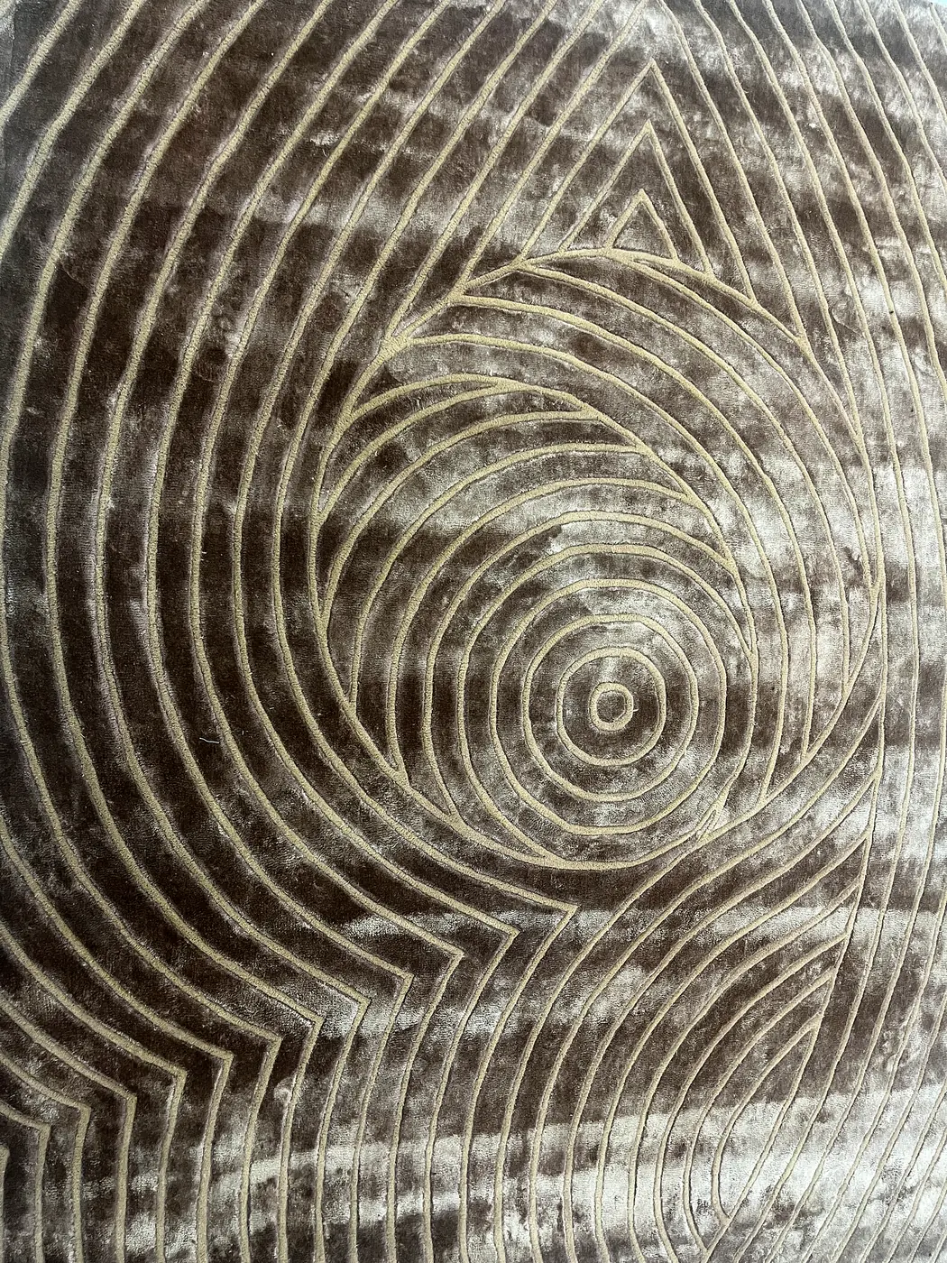Detail of a carved taupe wool rug